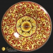 Piatto in maiolica Siciliana delle Ceramiche Artistiche di Agatino Caruso. Dipinto con ornato in giallo ocra e fondo rosso intenso